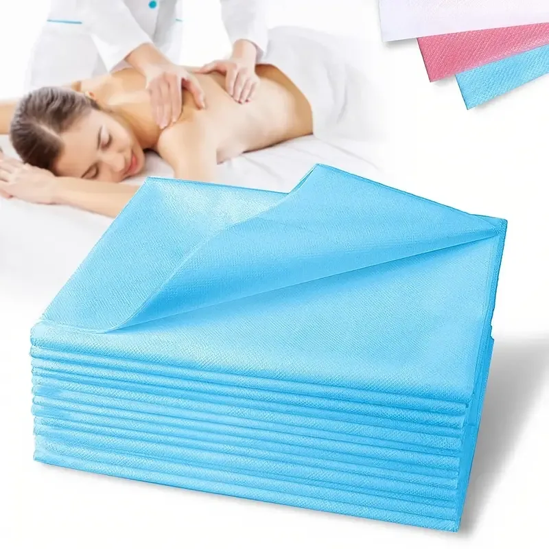 Blue disposable non-woven bed sheets stacked for massage table and spa salon