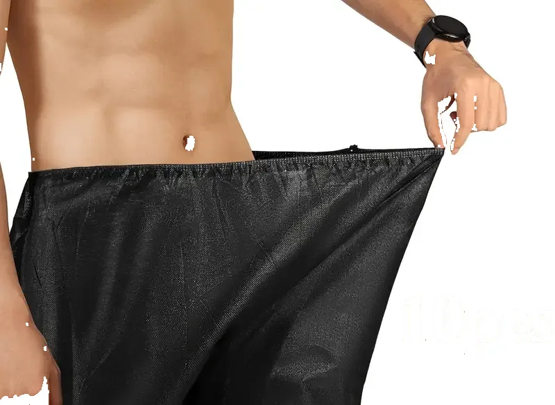 Black disposable non-woven boxer shorts stretched to show elastic waistband for bulk spa salon supply
